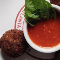 Arancini · 4 lightly fried rice balls with fresh mozzarella, seasoned beef and peas, served with Ragu’ ...