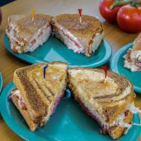 The Rachel * · Turkey, Coleslaw, Swiss Cheese, Russian Dressing Grilled on Marble Rye. Served with Side Ite...