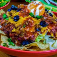 Taco Salad * · Tortilla Chips topped with Shredded Iceberg Lettuce, Cheddar Cheese, Black Olives & Green On...
