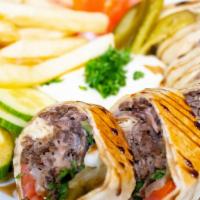 Steak Shawarma Sandwich · Slow cooked meat on a rotating skewer thinly sliced and put in a pita along with in-house ma...