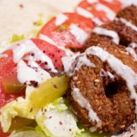 Falafel Sandwich · Falafel with lettuce, tomatoes, pickles and tahini sauce rolled in pita bread wrap.