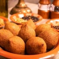 Fried Kibbeh · Arabic style stuffed meatballs. Made with bulgur wheat, minced beef shell, stuffed with saut...