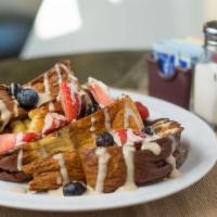 French Toast · Super thick slices of challah bread, topped with seasonal fresh fruit & French cream with br...