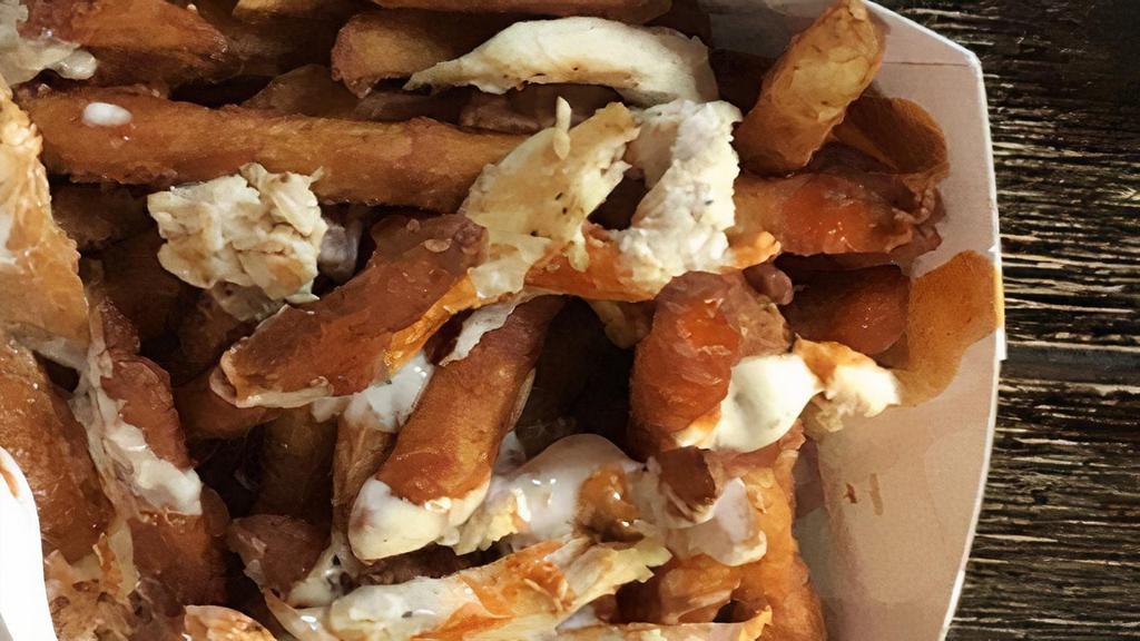 Buffalo Chicken Fries · Crispy fries topped with pulled Buffalo chicken, blue cheese dressing, and crumbles.