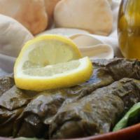 Veggie Grape Leaves · Savory vine leaves stuffed with rice, tomatoes, onion, and parsley.