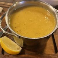 Lentil Soup · Blended yellow lentils served with a lemon wedge and bread croutons.