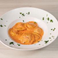 Ravioli Di Aragosta · Ravioli pasta stuffed with lobster meat. Served on pink sauce.