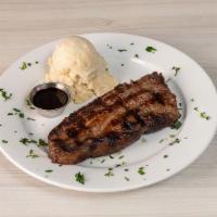 New York Steak · Black Angus cooked in the brick oven with red wine, fresh herbs, and served with homemade ma...
