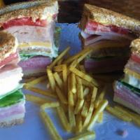 Club Sandwich La Suiza · On Toasted Wheat Bread: Ham, Turkey, Swiss Cheese, American Cheese, Tomato, Lettuce, Mayo, B...