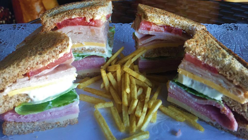 Club Sandwich La Suiza · On Toasted Wheat Bread: Ham, Turkey, Swiss Cheese, American Cheese, Tomato, Lettuce, Mayo, Butter and Olive Oil
