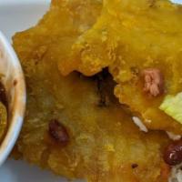 Tostones · Fried green smashed plaintain.