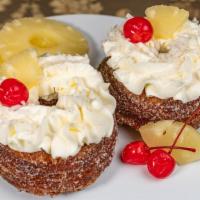 Pina Colada · Frosting made with condensed milk and powdered sugar topped with a cherry and pineapple.