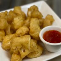 Thai Calamari · Lightly battered, fried calamari, served with special cucumber sweet and sour sauce.