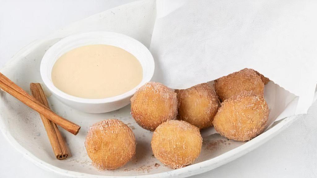 Thai Donuts · Scratch-made donuts freshly fried to order and tossed with Saigon cinnamon and cane sugar. Served with sweetened condensed milk dipping sauce. (6 donuts per serving)