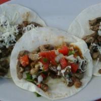 Taco (Beef) · A crunchy or soft flour tortilla filled with ground beef, lettuce, and shredded cheese.