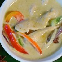 Green Curry · Green curry paste in coconut milk with green bean, bamboo shoot, eggplant and basil. Spicy.