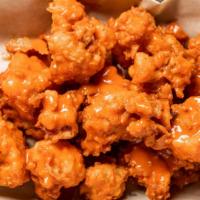 Buffalo Cauliflower · Vegetarian. Battered and fried cauliflower tossed in buffalo with ranch or blue cheese.