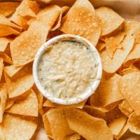 Spinach & Artichoke Dip · Topped with parmesan and served with tortilla chips.
