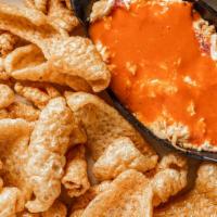 Buffalo Pimento Cheese Spread · Served with corn chips. Sub chicharrones for an additional charge.