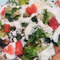 Tostada · choice of protein, refried beans, lettuce, tomato, sour cream, cheese on a crispy flat corn ...