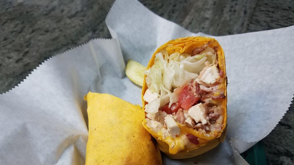 Chicken Club Wrap · Grilled chicken  wrapped with bacon, lettuce, tomato, cheddar jack cheese and ranch dressing.