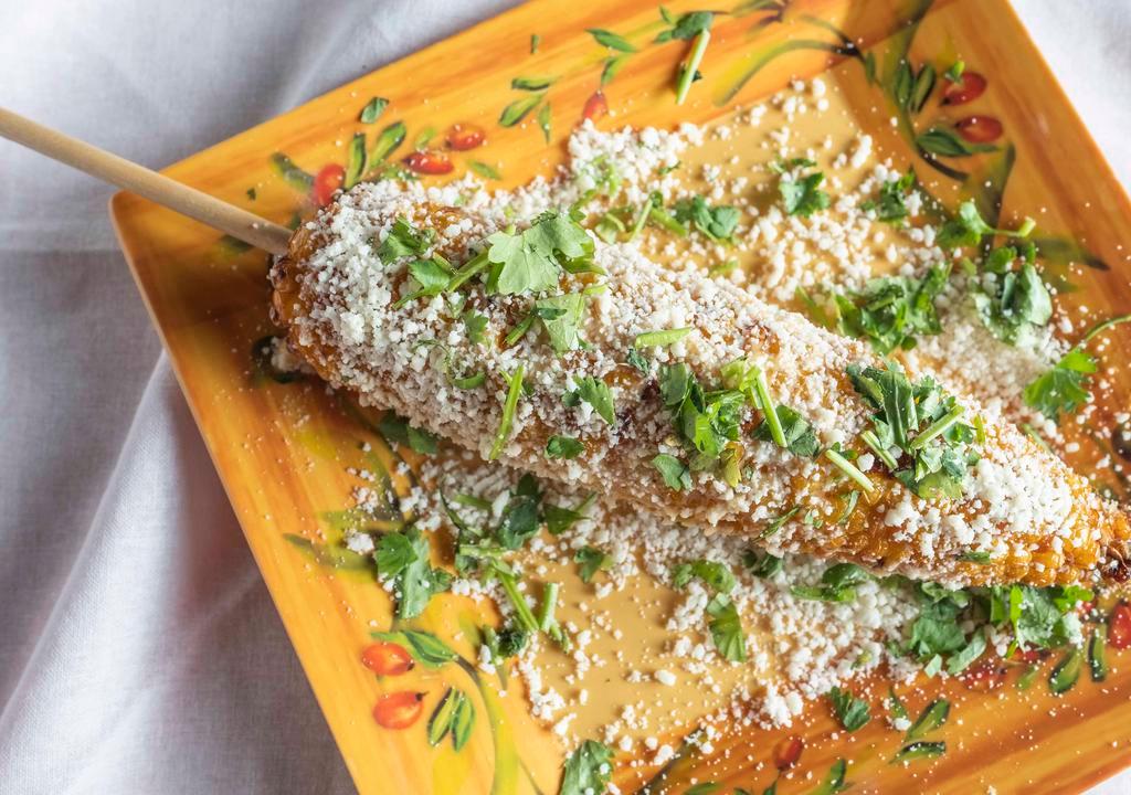 Mexican Street Corn · Deep-fried coated with fresh cilantro, cotija cheese, and Lola's adobo.