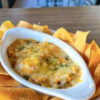 Curry Chicken Dip · All of that goodness from the empanada without the guilt…….JK, we serve this with fried chips.