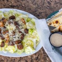 Caesar Salad · Romaine lettuce, Parmesan cheese, and croutons. Topped with caesar dressing.