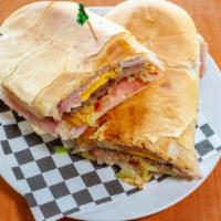 4 - Chivito Especial · Cuban Bread Toasted with Steak, Ham, Cheese, Bacon, Egg, Lettuce, Tomatoes, Potatoes Sticks,...