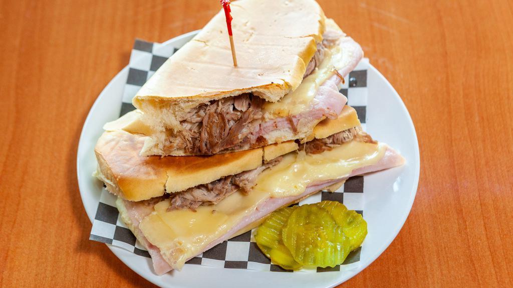 1 - Cuban Sandwich · Cuban Bread Toasted with Pork, Ham, Cheese, Pickle, Mayo, and Mustard