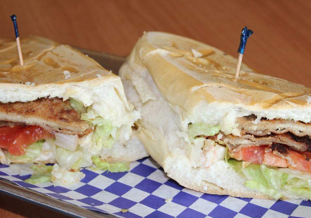 23 - Milanesa Sandwich · Cuban Sandwich Toasted with Breaded Steak or Breaded Chicken, Lettuce, Tomato, Onion, and Mayo
