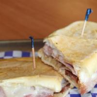 22 - Bistec De La Casa · Cuban Bread Toasted with Steak, Sausage, Cheese, Ham, Onion, and Mayo