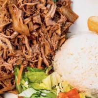 Lechon Asado · Slow roasted pork marinated in a traditional sour orange mojo. Served with white rice, yuca ...