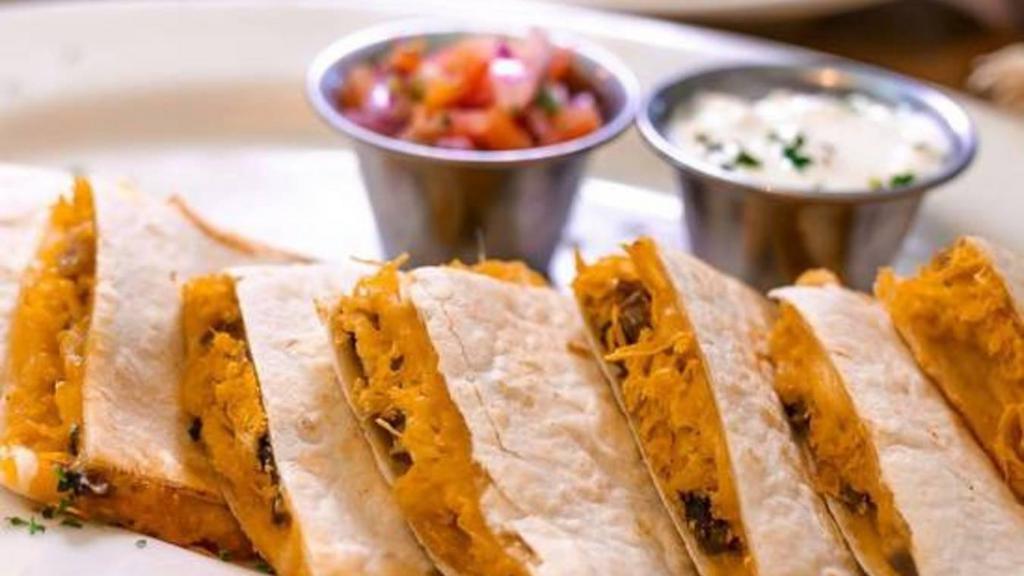 Quesadilla De Pollo Y Champinones · Chicken and mushroom quesadilla. Grilled chicken, sauteed with mushrooms, onions, peppers, and mixed cheese in a grilled flour tortilla.