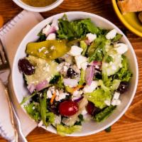 Greek Salad · Crisp lettuce, tomato, cucumber, onion,  pepperoncini, Greek olives, and feta cheese.