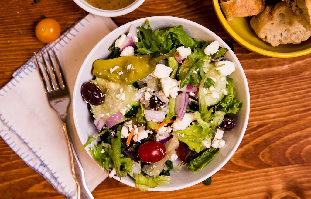 Greek Salad · Crisp lettuce, tomato, cucumber, onion,  pepperoncini, Greek olives, and feta cheese.