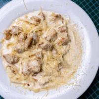 Chicken Alfredo · Sauteed chicken with fettuccine pasta,  tossed in a creamy parmesan butter sauce. Served wit...