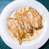 Chicken Carbonara · Grilled chicken over penne pasta tossed in a creamy sauce with bacon, ham, and peas. Served ...