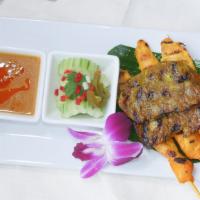 Satay · Gluten-free. Thai herb and curry powder-marinated meat on the skewer brushed with coconut cr...