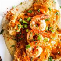 Cajun Creole Gulf Shrimp Fish And Grits · Crispy Flounder over a bed of grits topped with cajun creole sauce and gulf shrimp garnished...