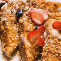 Gocha’S Krunch-Tastic · Crunchy battered French toast with mixed berries powdered sugar and our house vanilla bean s...