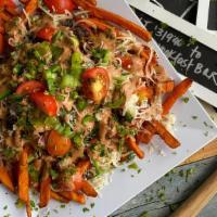 Impossible Sweet Potato Nachos · Succulent sweet potatoes covered with impossible meat, black bean salsa, cherry tomatoes, re...