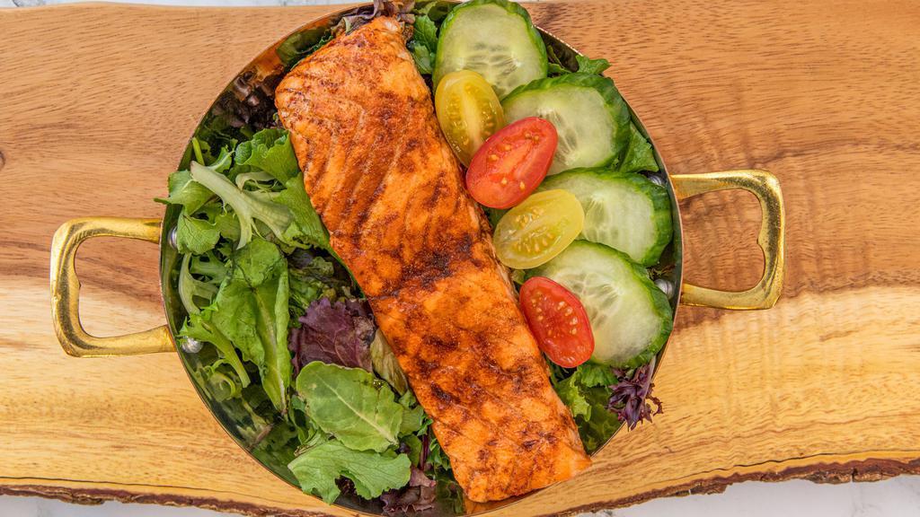 Balsamic Salmon Salad · Grilled salmon filet over lettuce with finely cut onions, celery, almonds and apples with a balsamic dressing.
