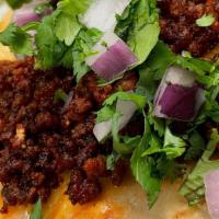 Chorizo Taco · Mexican sausage served with onions and cilantro on a corn soft tortilla.