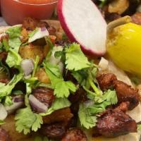 Pastor Taco · Roasted pork marinated in achiote and spices, serve with fresh pineapple, onions and cilantr...