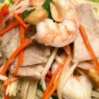 Green Papaya Salad · Served with shredded green papaya, carrot, mints, poached shrimp, sliced pork tossed in home...