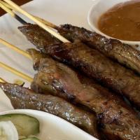 Satay Beef Or Chicken · Sliced lean fillets marinated in Thai spices, skewered & char-grilled served with peanut sau...