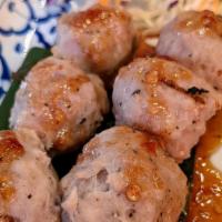 Look Chin Ping · Homemade, char-grilled meatballs served with homemade tamarind sauce. *Thai meet ball*