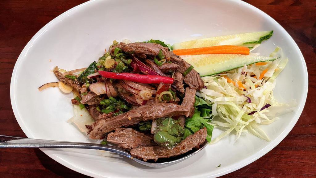 Spicy Beef Salad · Grilled marinated lean beef, tomatoes, red onions & cucumber tossed in spicy lime sauce with romaine