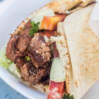 Beef Shawarma · Beef, lettuce, tomato, onion, parsley, pickles, tahini sauce, and garlic sauce.